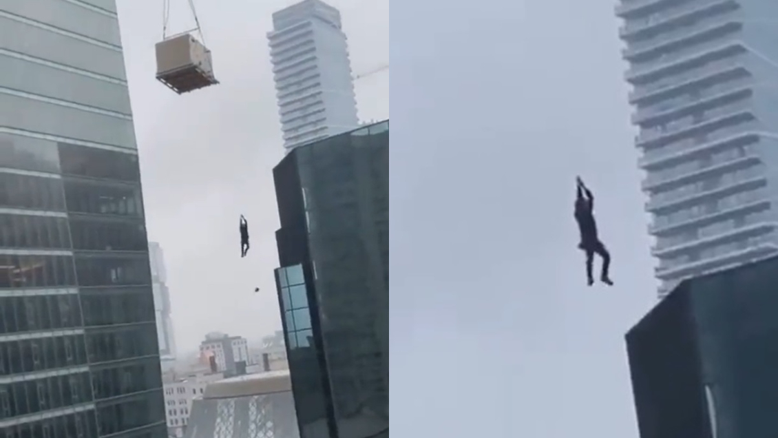 Hombre quedó colgado de una grúa a varios metros del piso en un edificio en construcción