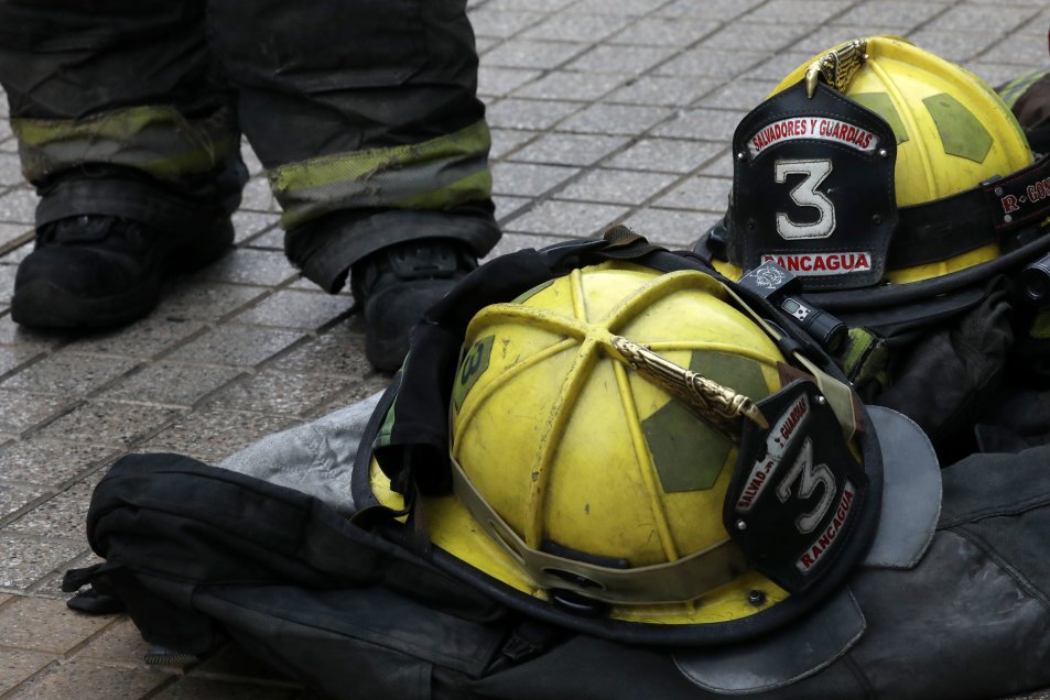 Bombero con uniforme y casco adulto bombero de pie