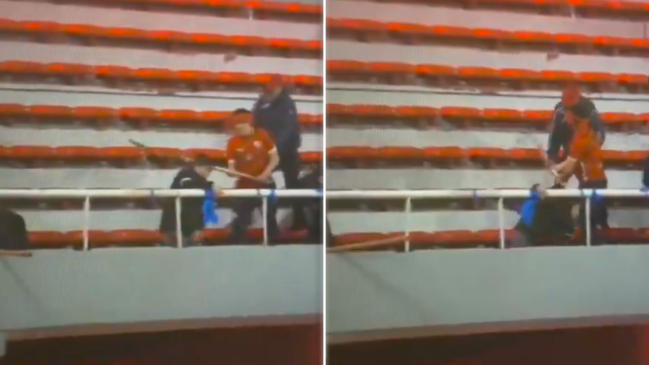 [VIDEO] Hincha de la U cayó desplomado tras golpe en la cabeza con un tablón